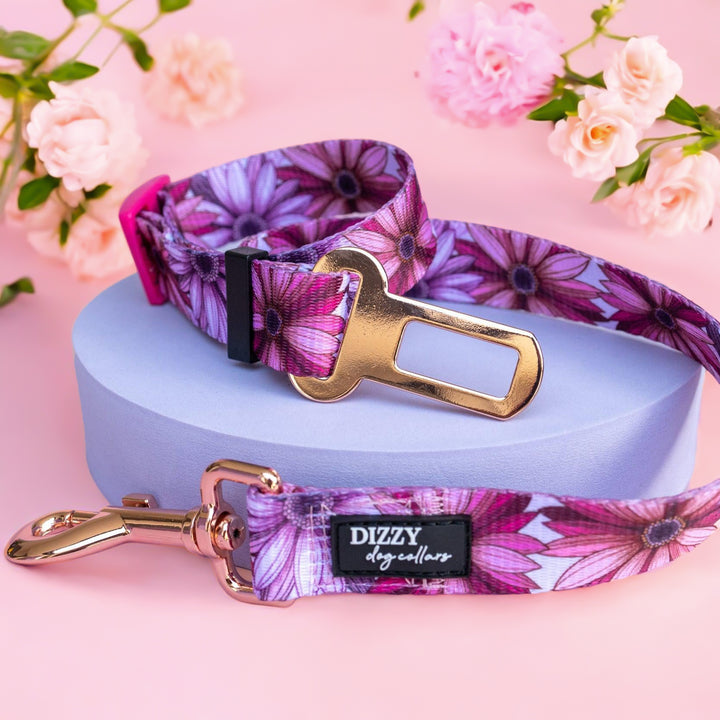 Perfect Petals Dog Car Restraint  Description: Ensure your pet's safety during car rides with this stylish car restraint. Featuring the same vibrant floral pattern, it includes a secure buckle and rose gold hardware. The adjustable design allows for a comfortable and safe fit, making car trips both secure and stylish for your furry friend.